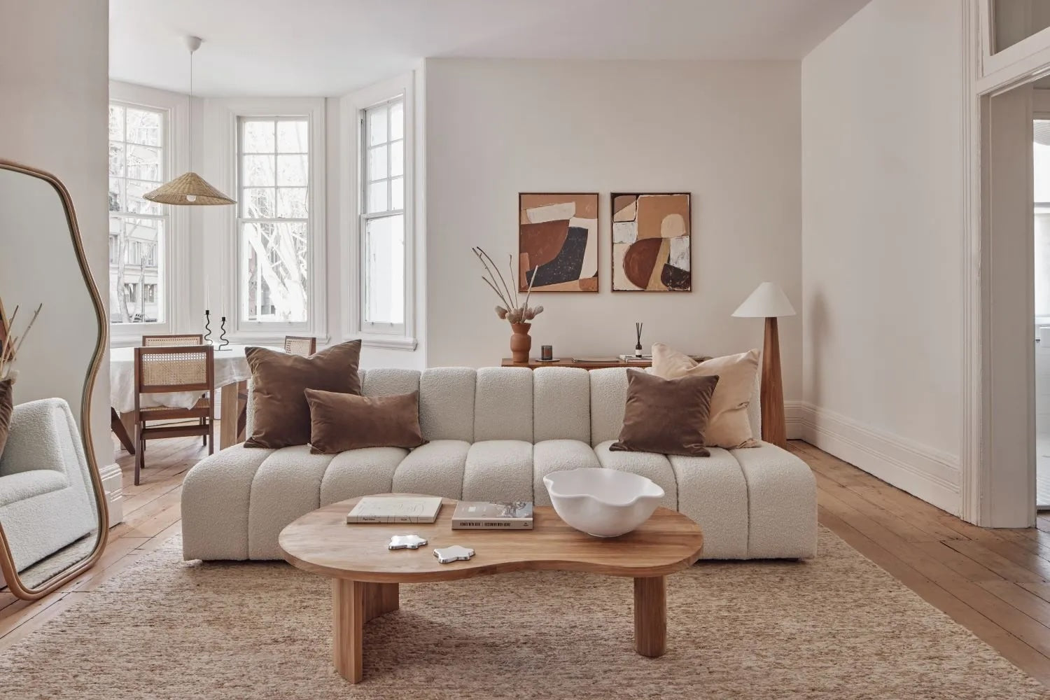 Modern living room with a beige sofa, wooden coffee table, and abstract art on the wall showing where you can use protectME