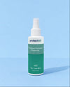 A 125ml spray bottle of protectME Premium Footwear Protector, featuring a white upper and a green lower label, set against a solid light blue background.